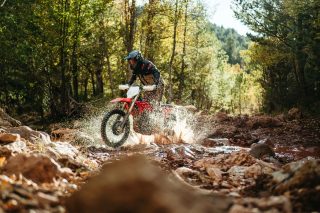 オフロードバイクが水しぶきを上げている様子