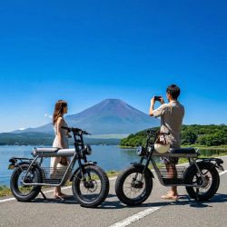 富士山を背景に電動バイクに乗るカップル
