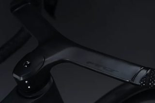 光沢のある黒い自転車のカーボン製一体型ハンドルバーのクローズアップ画像