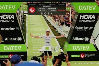 フィニッシュラインを通過するトライアスロン選手